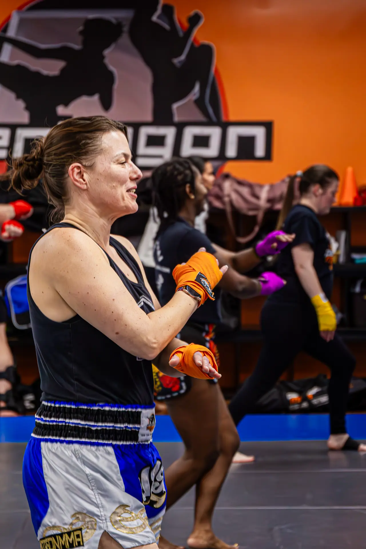 Through Muay Thai technique, including pad holding techniques, heavy bag work, jumping rope, and lifting weights, students work hard while mastering the eight limbs — fists, knees, elbows, and shins — in the correct way.
